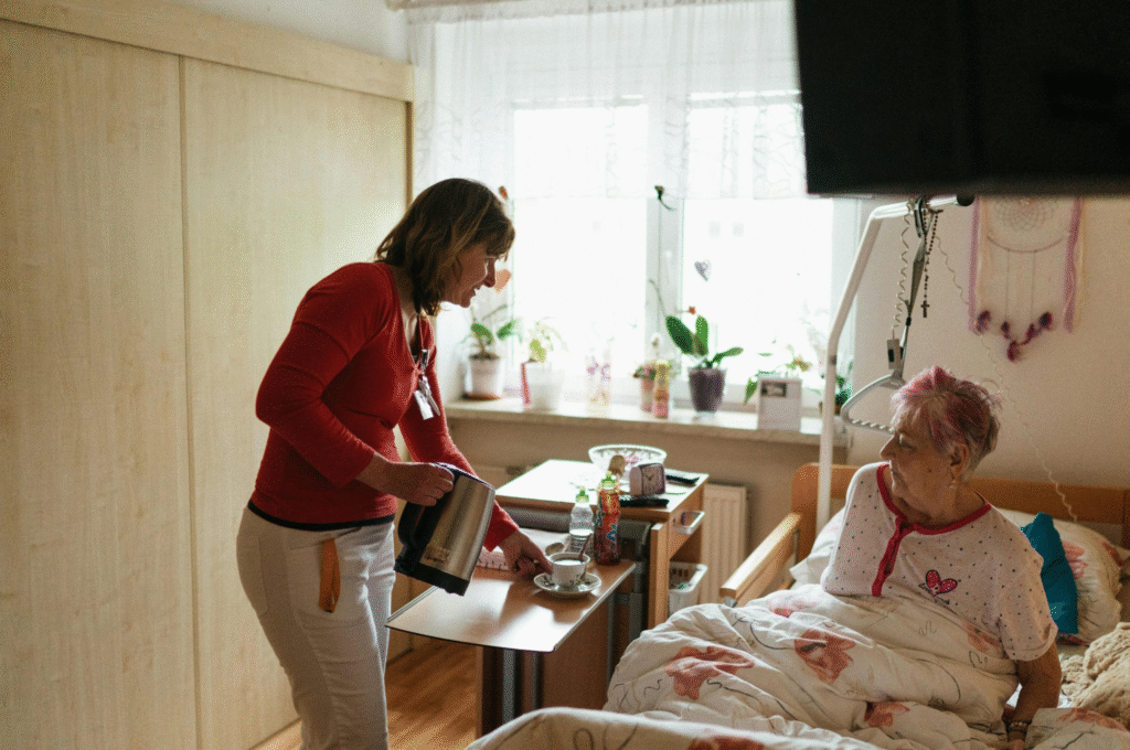 A home care worker with a post hospitalization elderly person at home.