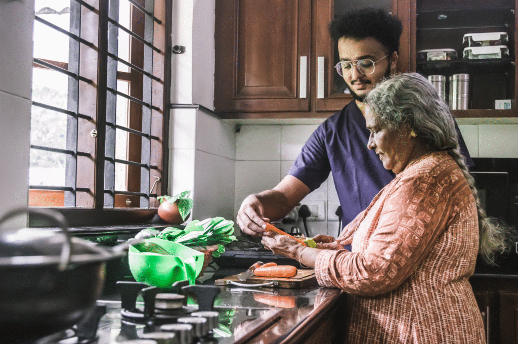 A home care worker helping an elderly person to prep for meal.